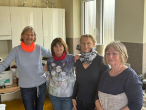 Vier Menschen stehen zusammen in einem Raum